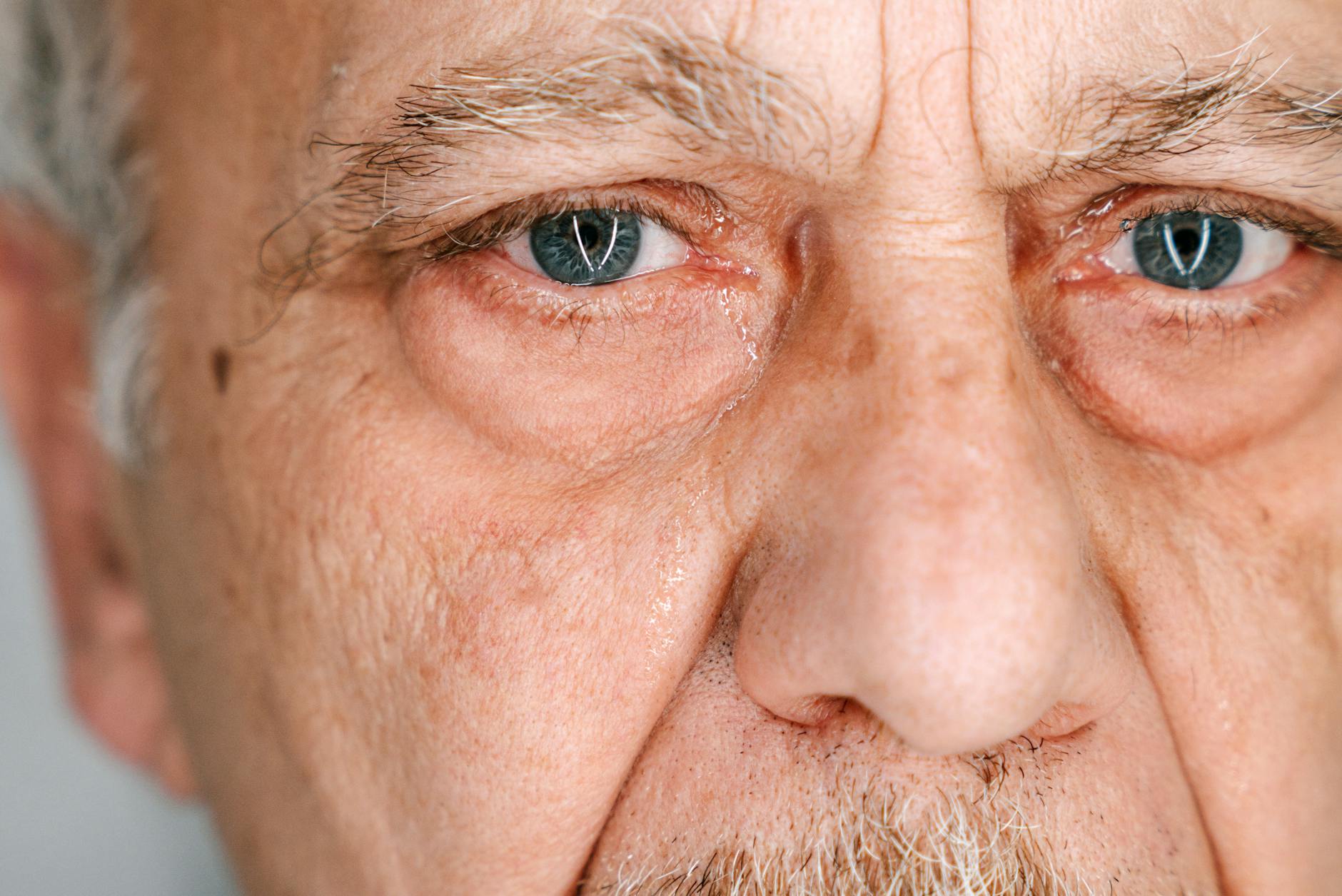 https://www.pexels.com/photo/close-up-shot-of-an-elderly-man-crying-8964680/